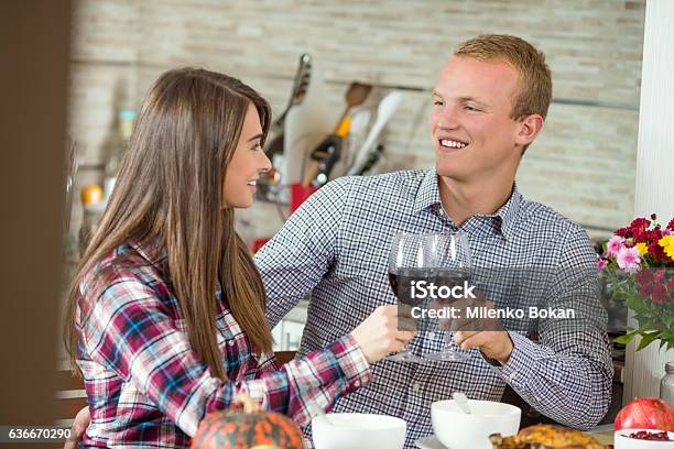 Young Couple Having Dinner At Home Stock Photo - Download Image Now - Thanksgiving - Holiday, Romance, Dining Table