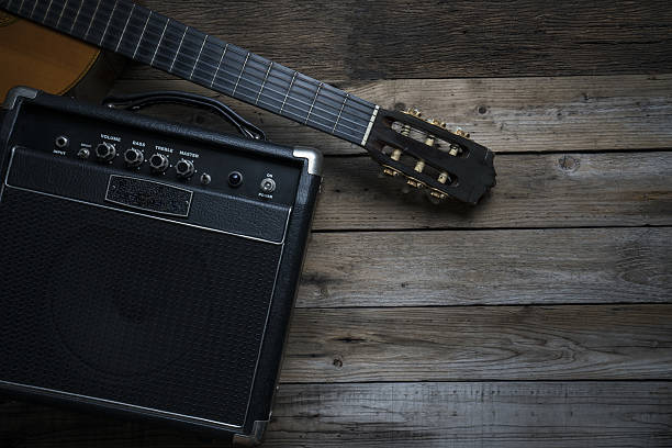 istock Guitar amplifier and guitar on wood table 636674890