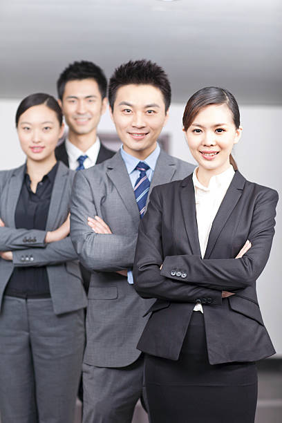 istock Four young office workers with hands crossed indoors,portrait 636675010