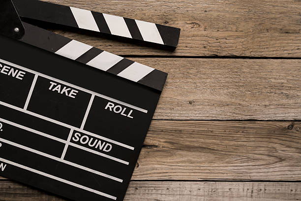 istock movie clapper on wood table 636676152