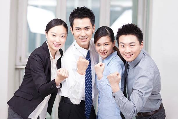 istock Group of young business people cheering 636678914