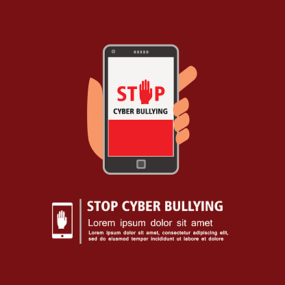 Hand holding smart phone with stop cyber bullying campaign on screen