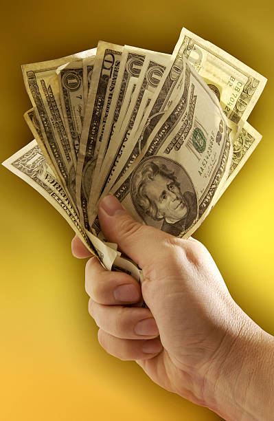 istock Money - A handful of Dollars 636685784