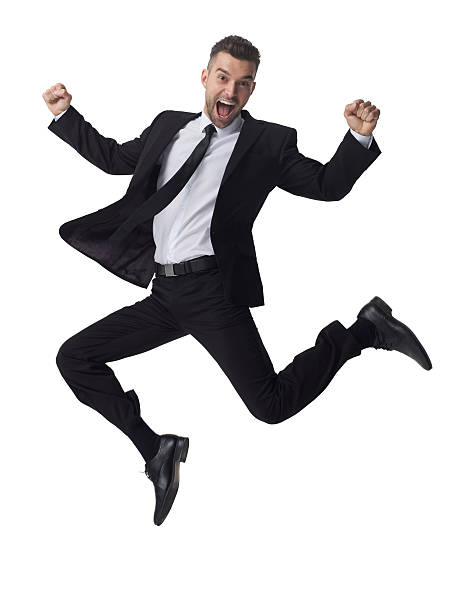 Businessman jumping and celebrating success stock photo