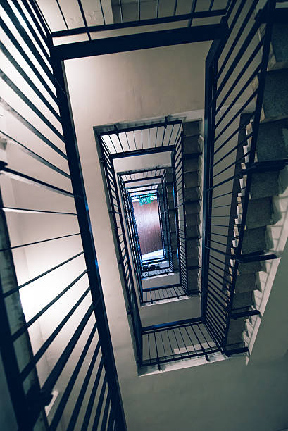 istock Residential building staircase from below 636688256