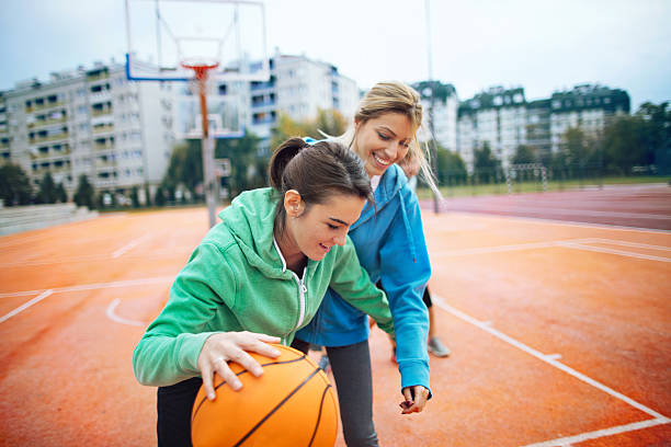 istock Girls playing basketball 636688610