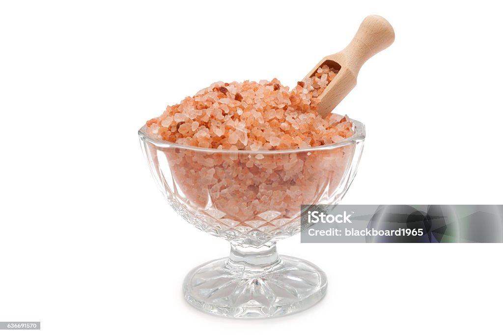 Himalayan salt Himalayan salt in glass bowl with wooden scoop on white background Asia Stock Photo