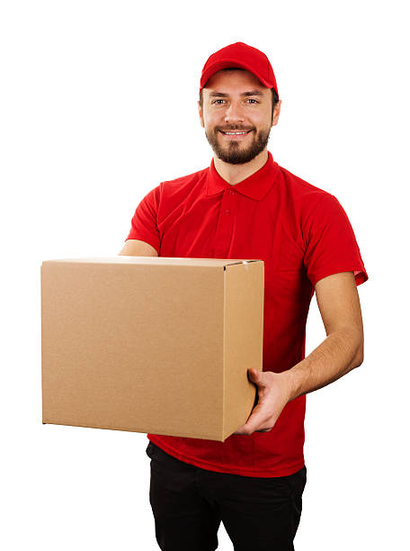istock delivery service - young smiling courier holding cardboard box 636694376