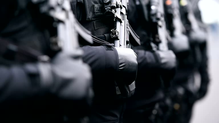 Soldier holding automatic gun during a military parade