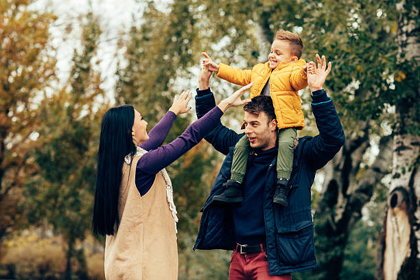 Young family have fun in park