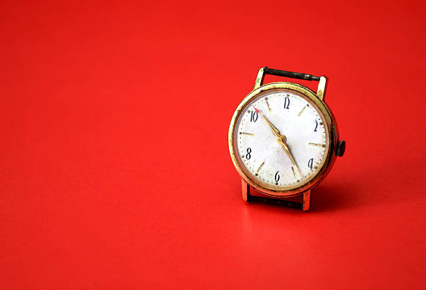 istock vintage old wrist watch on red background 636697048