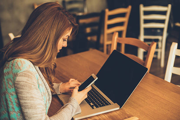 istock Young woman texting on the phone in cafe 636701336