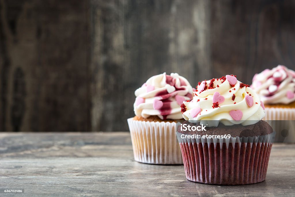 Valentine cupcakes Valentine cupcakes decorated with sweet hearts on wooden table Cupcake Stock Photo