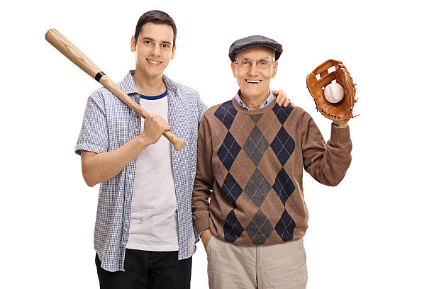 молодой человек с бейсбольной битой и старший в перчатке - baseball player baseball holding bat стоковые фото и изображения