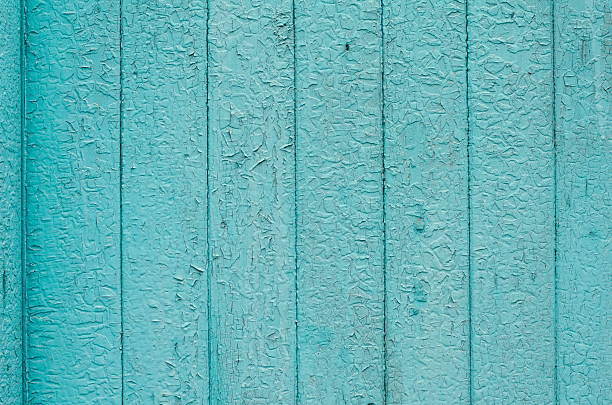 istock Cracked weathered green and blue painted wooden board texture 636706832