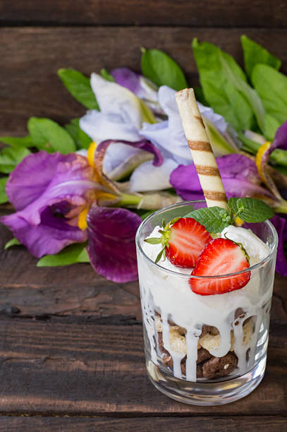 istock Ice cream with strawberries, mint and muesli. Wooden rustic table. 636707416