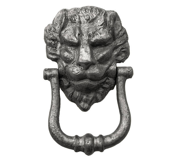 istock Lion head knocker on an old white wooden door 636708490
