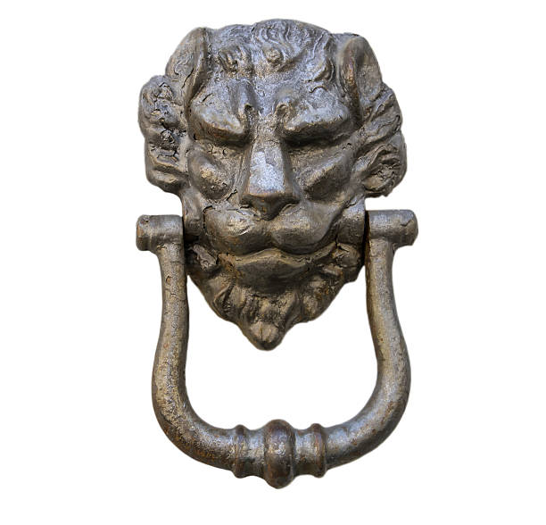 istock Lion head knocker on an old white wooden door 636708606
