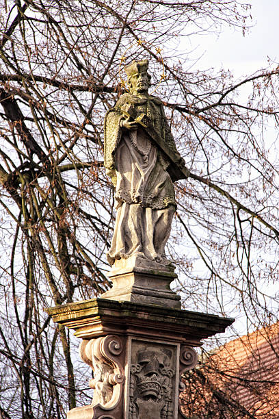 istock Old statue of the saint with the cross 636713432