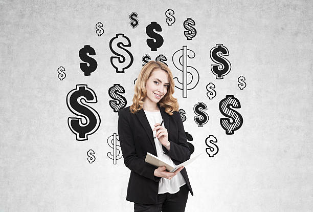 istock Redhead woman and dollar sign on concrete wall 636714546