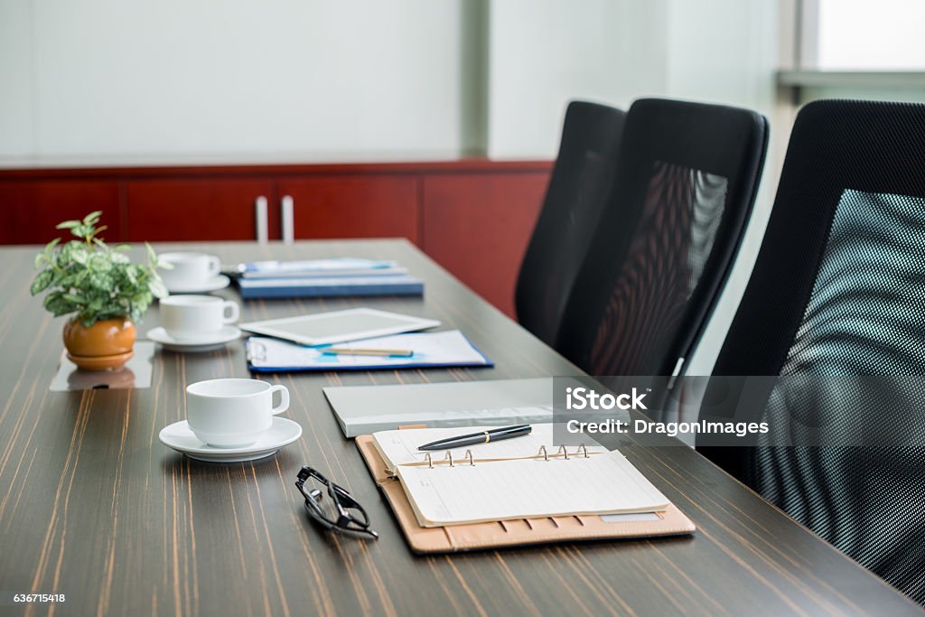 Everything for business meeting Table with notepads and coffee cups for business meeting Business Stock Photo