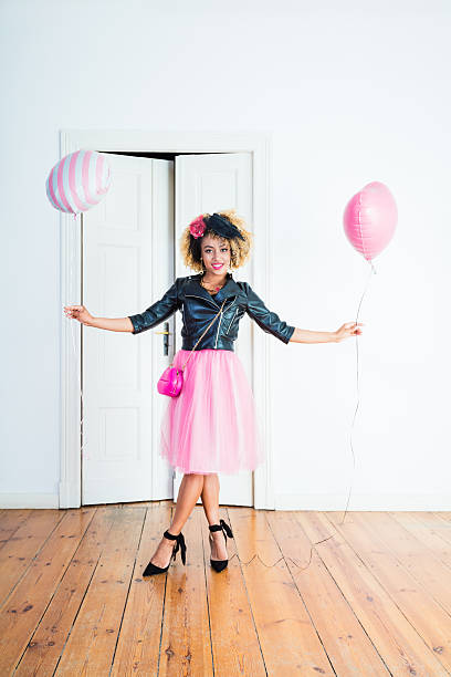 istock Beautiful woman holding balloons 636715600