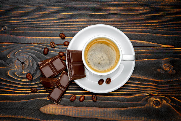istock fresh cookies and coffee on wooden background 636716422