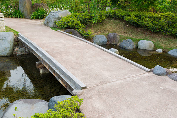 istock Stone path in Garden, stone bridge, across a pond. 636718244