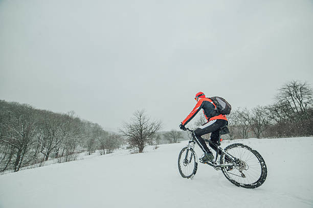 istock Extreme cyclist rides in the winter snowy forest 636718644
