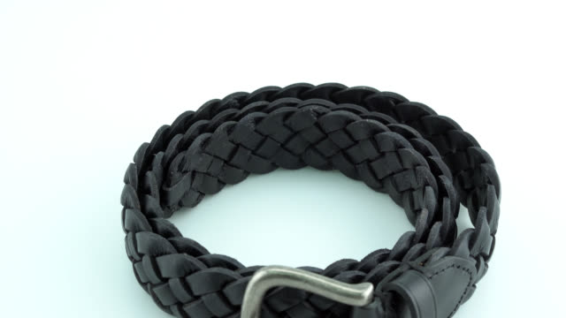 Black leather belt on white background