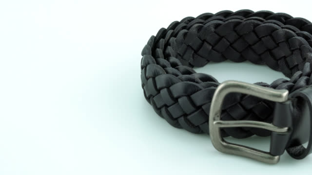 Black leather belt on white background