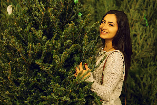istock girl and Christmas tree 636719748