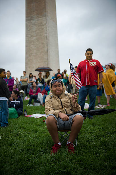Washington DC, USA - July 4, 2016: Jhonn, age 10, celebrates the Fourth of July on the National Mall in Washington DC.