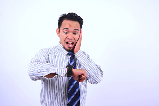 Happy businessman holds a clock