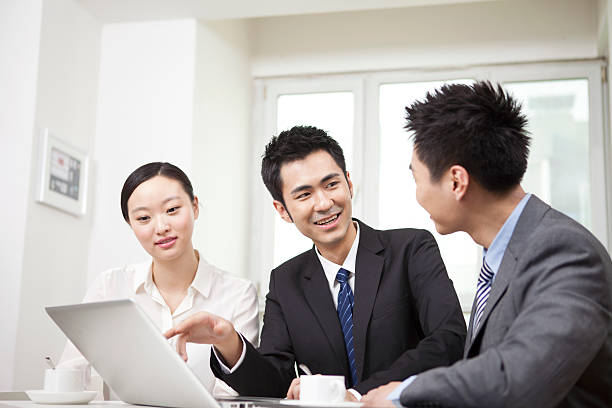istock Group of businesspeople discussing,working on computer 636725590