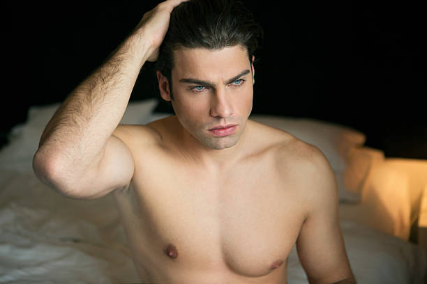 istock Portrait of a shirtless man in bed 636725978