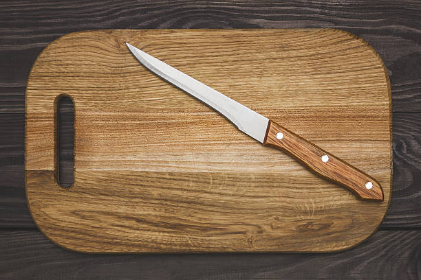 istock cutting board on wooden background with a knife 636726162