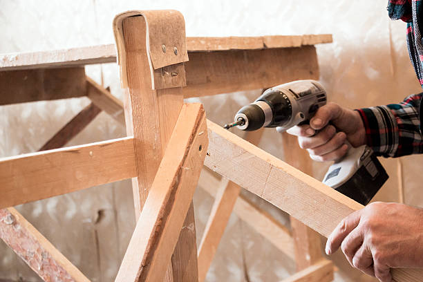 istock Man Screwing a screw into the wood 636726696