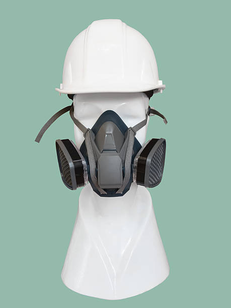 istock Dust mask and helmet on mannequin. 636727628