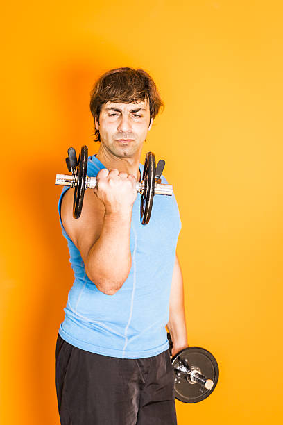 istock Adult man doing exercise with dumbbells at home 636727816
