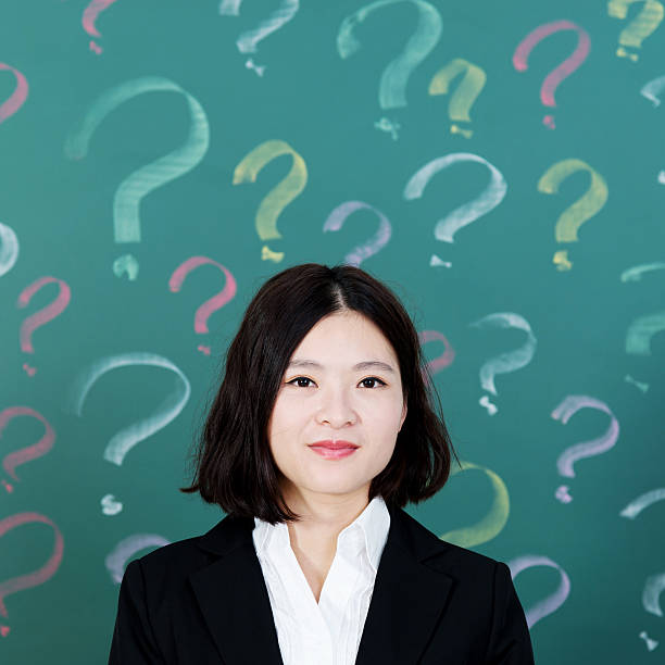 istock Businesswoman with question marks 636729684