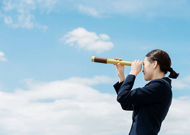 istock Businesswoman with telescope 636732916