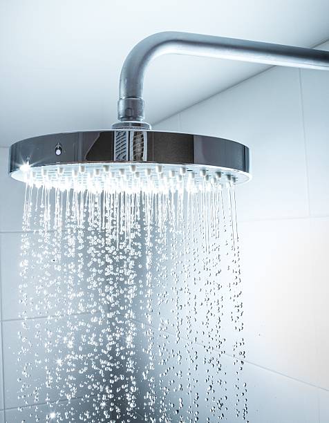 Shower Shower Head with Water Stream on Grey Background shower head stock pictures, royalty-free photos & images