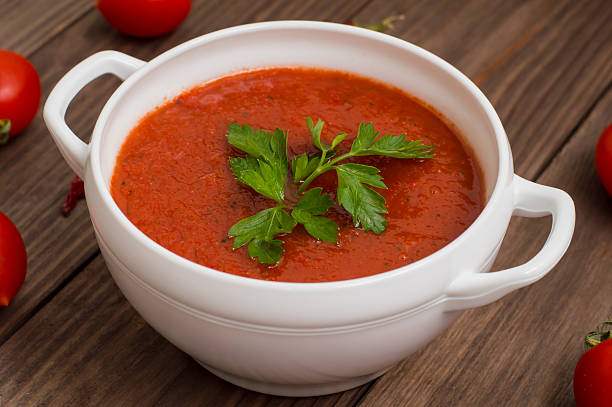 istock Gazpacho with vegetables. Wooden rustic background. Top view 636735392