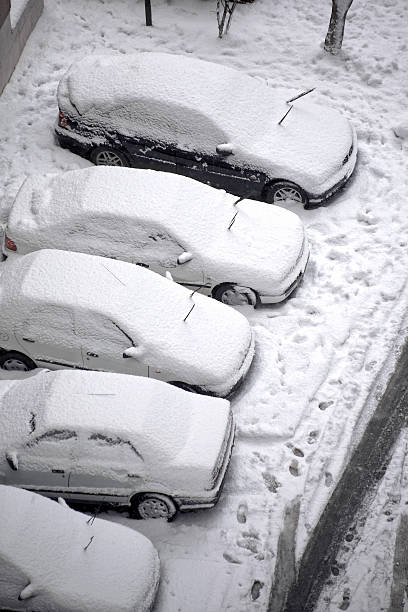 istock snow covered cars 636736410