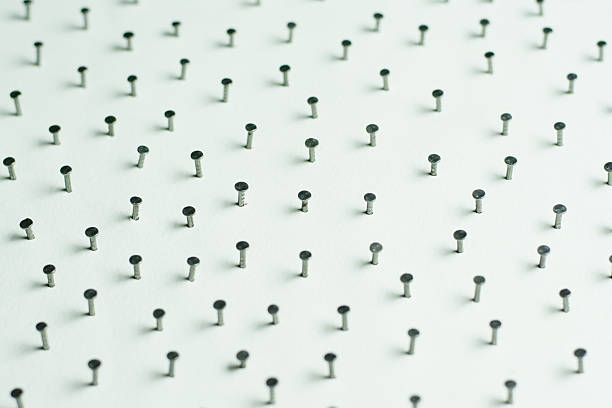Bunch of multicolor push pins on white background.