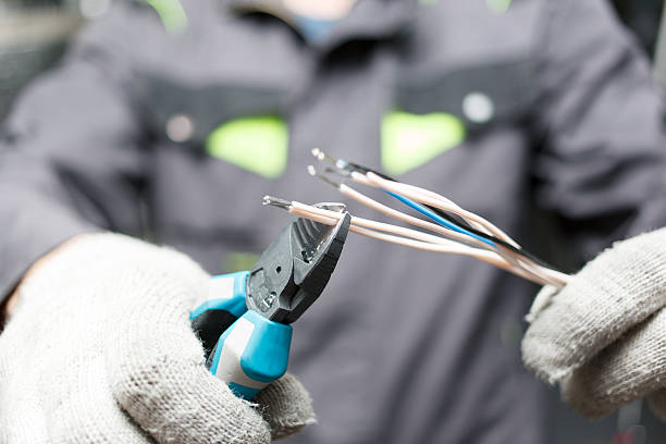 istock Hands of young electrician. 636737552