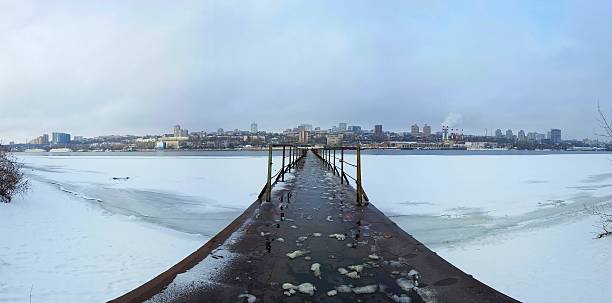 istock Frozen old pier at river side in winter time. 636737946