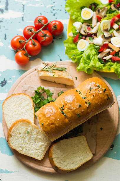 istock Garlic bread with salad and cherry tomatoes on wooden background 636741776