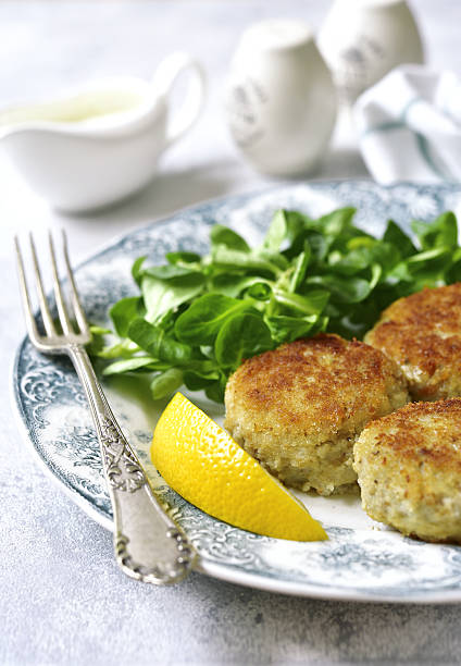 istock Fish cutlets with cream sauce on a vintage plate.Top view. 636742920